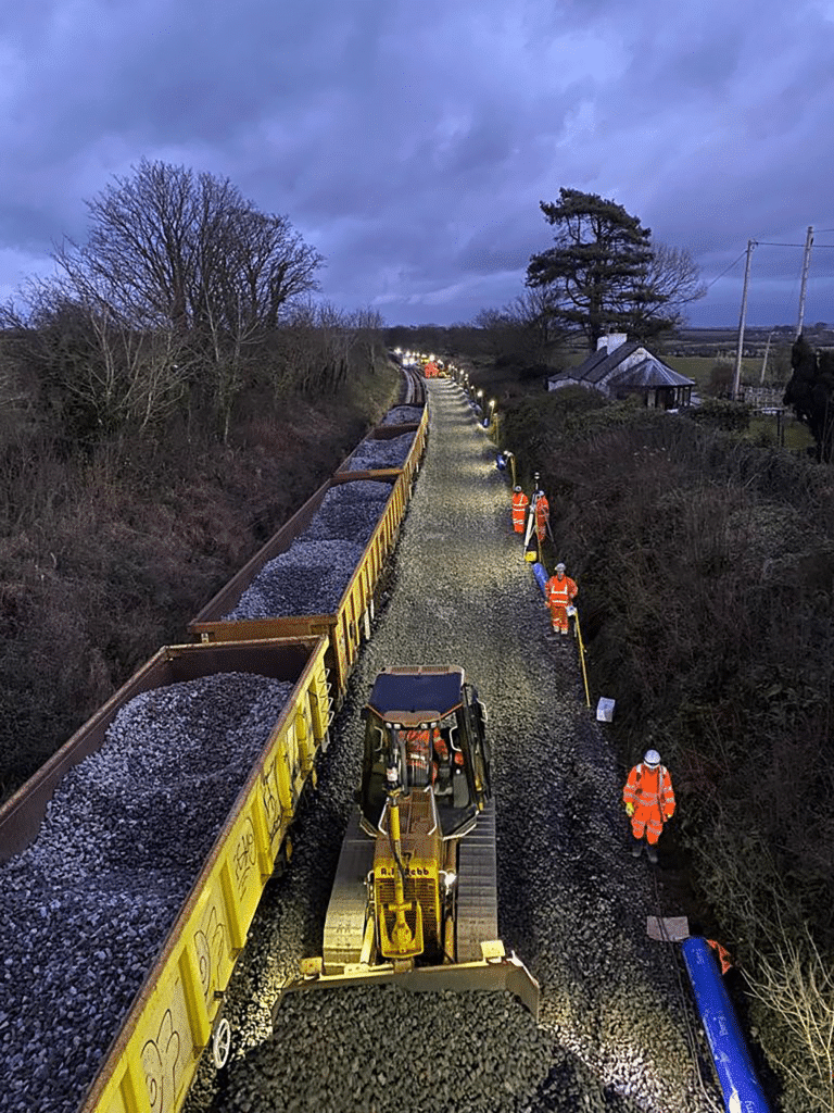 Protrack trackside at night with workers